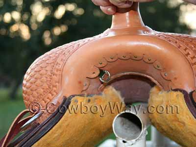 Put your dee-ring under the loosened leather